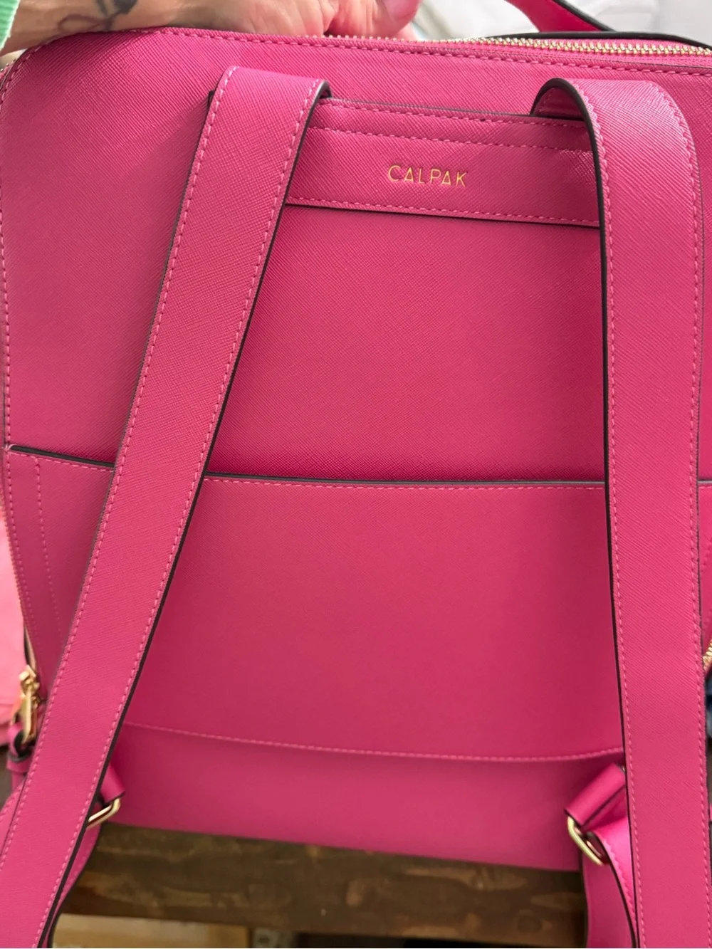 CALPAK Kaya Laptop Backpack in the vibrant Dragonfruit hot pink